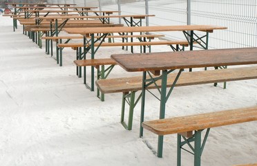 Row of empty tables and benches