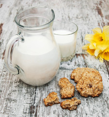 jug with milk and oatmeal cookies