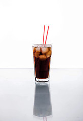 Cola in a glass with ice with red tube. soft drinks