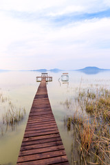 Obraz premium Wooden pier in tranquil lake Balaton