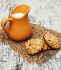 jug with milk and oatmeal cookies