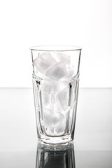 Glass with ice cubes. Isolated on white