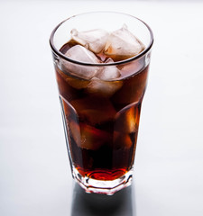 soft drinks. Cola glass with ice cubes on a white background