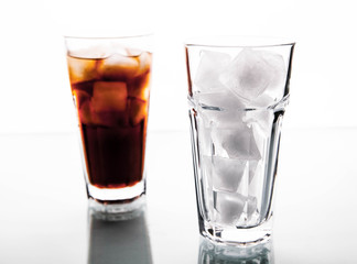 soft drinks. Cola glass with ice cubes over white