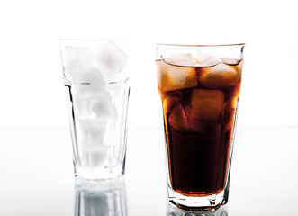 soft drinks. Cola glass with ice cubes over white