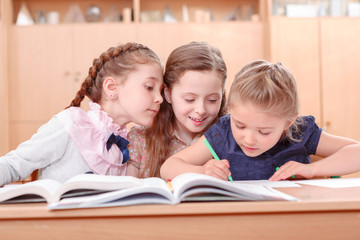 Fototapeta na wymiar Girls with opened books in classroom 