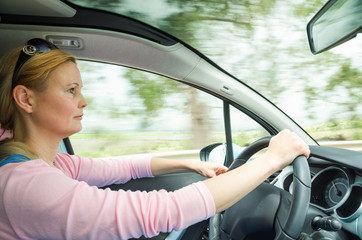 Profile portrait of serious calm woman carefullly safe driving