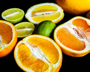 Fototapeta na wymiar sliced citrus fruit on a black background. food