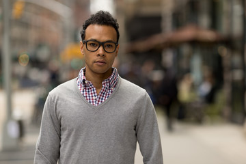 Young African Asian man in New York City serious face portrait