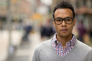 Young African Asian man in New York City serious face portrait