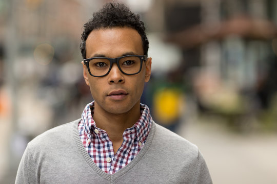 Young African Asian man in New York City serious face portrait