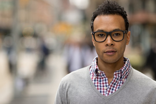 Young African Asian man in New York City serious face portrait