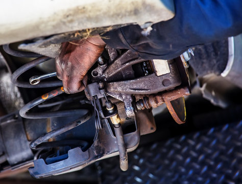Closeup of car mechanic repairing brake pads