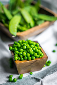 Peas on wooden background