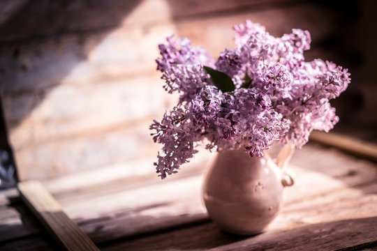 Bouquet of lilacs on wooden background