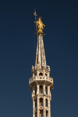 Fototapeta na wymiar Statue of the Madonna on top of the Milan Cathedral