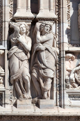 Fototapeta na wymiar Statues decorating the exterior of the Milan's Duomo