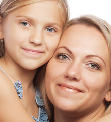 Portrait of a joyful mother and her daughter smiling at the came