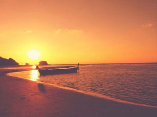 The floating boat with beautiful sunset in vintage sytle