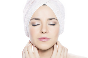 Beauty shot of a woman with eyes closed, and a towel