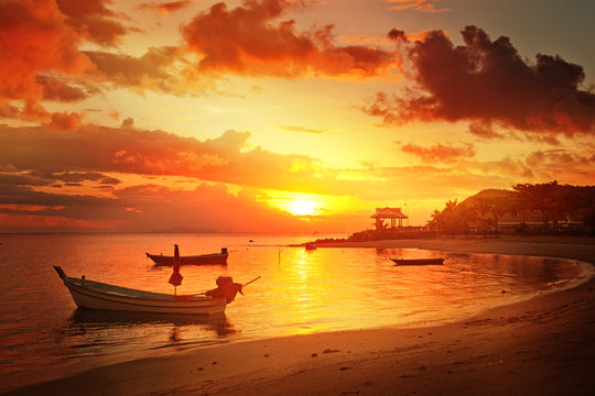 Traditional thai boats at sunset beach