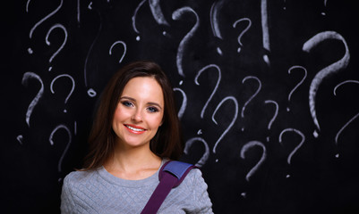 Young girl with question mark on a gray background