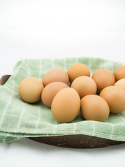 Eggs with cloth in basket on white background.