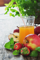 fruit juice, ripe apples and strawberries