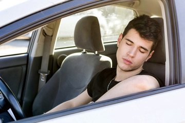 Handsome Young Man sleeping in a Car 