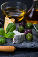 Tapas style cheese selection with olives,grapes and herbs
