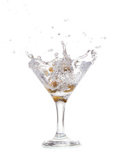 Splash from olive in a glass of cocktail, isolated 