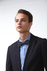 young handsome man in elegant suit with butterfly