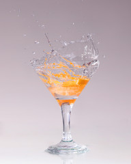 cocktail in a martini glass on a white background with fruit
