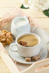 Fresh coffee with cinnamon, milk, sugar and cookies