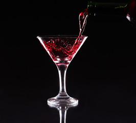 red splashing cocktail on black