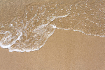 Fototapeta na wymiar Water and sand background on the beach