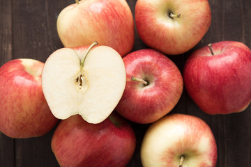 Half of red apple on wooden background