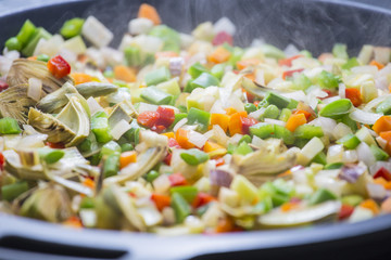 Cooking boiling Mediterranean veggies on a pan