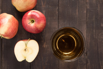 Top healthy apple juice drink and red apples fruits on wooden ba