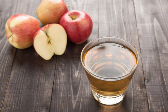 Healthy apple juice drink and red apples fruits on wooden backgr