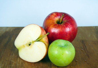Red and green apples, apple slice on wooden board