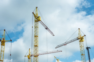 Construction site with cranes on the sky