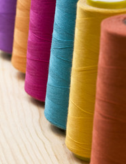 several of multi-colored spool of threads