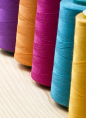 several of multi-colored spool of threads