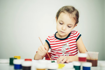 little 6 years girl with paint toy
