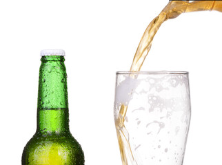 Pouring beer from bottle isolated on white background