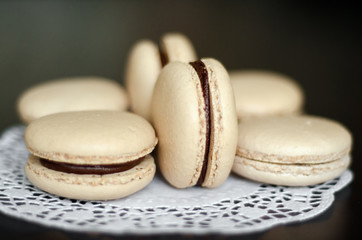 Beige macaroons with chocolate filling. 