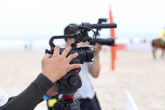 Cameraman working on recording on a beach Polo Tournament