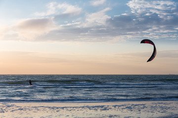 Kitesurfing in the evening along the Dutch coast