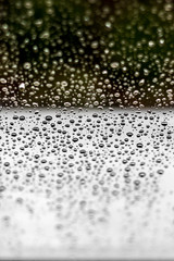 water drops on a window with green background - fading out